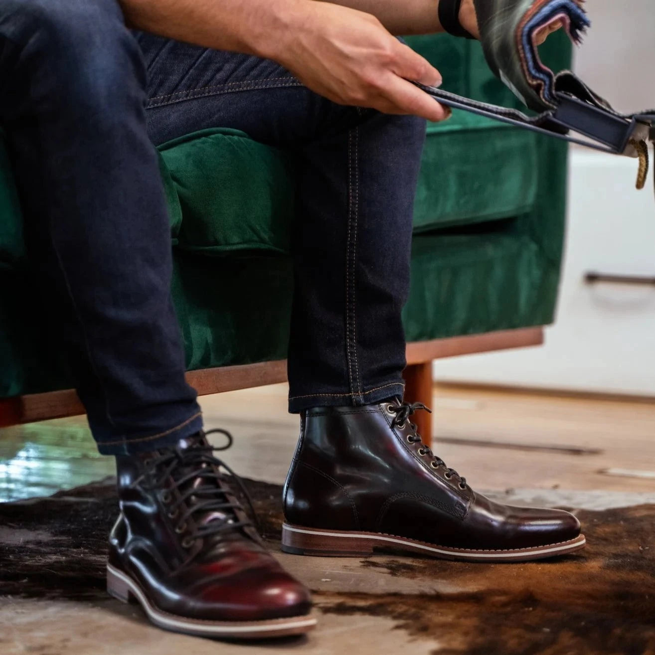 HELM - Closeup of man wearing Zind Burgundy sitting on couch